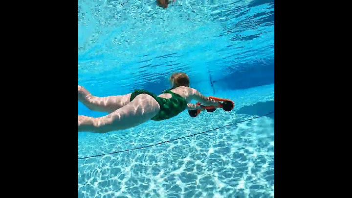 The little girl is diving by using MANTA sea scooter.