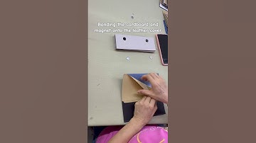 Bonding the cardboard and magnet to the leather cover. #notebook #officesupplies