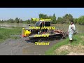 Tractor plowing rice field in Thailand