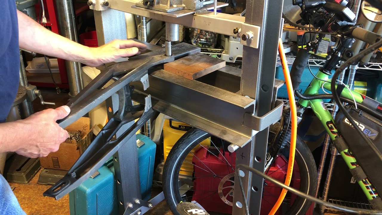 Press out SurRon inside swingarm bearings once outside bearings are