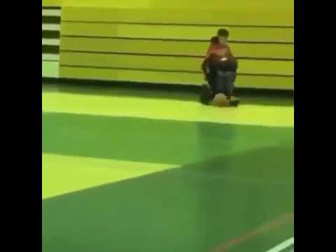 Boy in wheelchair plays with ball and falls