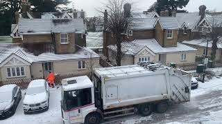 Weekly garbage collection on a snowy morning in London