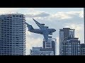 Plane Flies Between Buildings