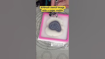 Airbrush stencil image onto a sugar cookie