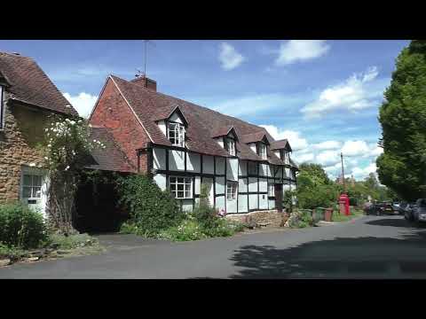 Driving On Main Street, Elmley Castle, Pershore, Worcestershire, UK 16th August 2023