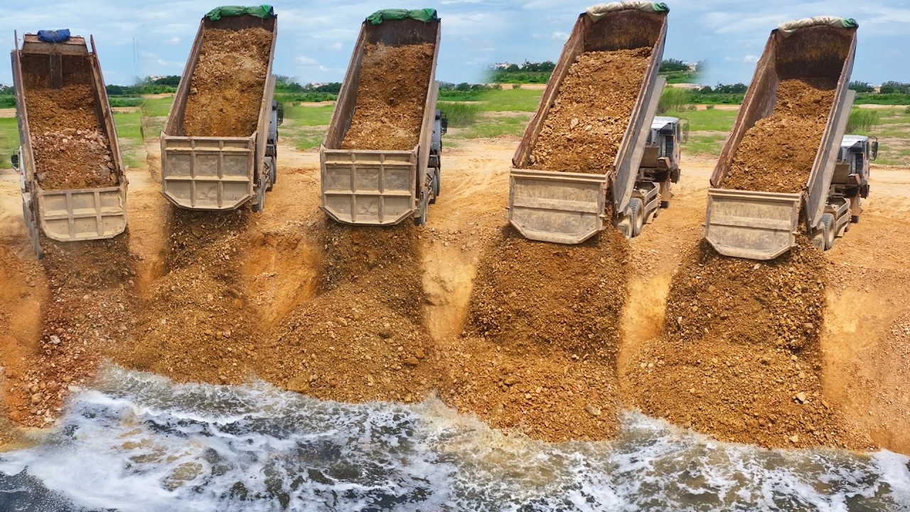 Great Fill up land! Processing Dump truck unloading soil with Dozer D60P PushingSoil drop into water