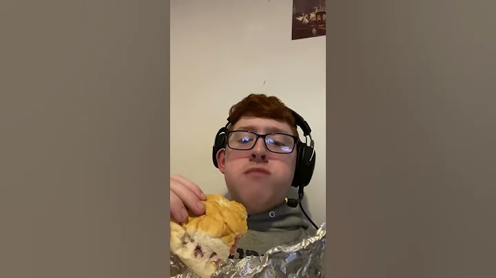 Red head man eats a sandwich