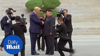 Moment Trump steps into North Korea to meet Kim Jongun