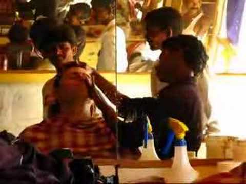 Inside a "hair saloon" in Badami, India. Shaves usually include a face massage with lotions & potions. All for about 25 cents.