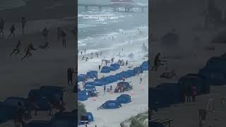 Footage captures waterspout ripping through crowded beach #Shorts screenshot 2