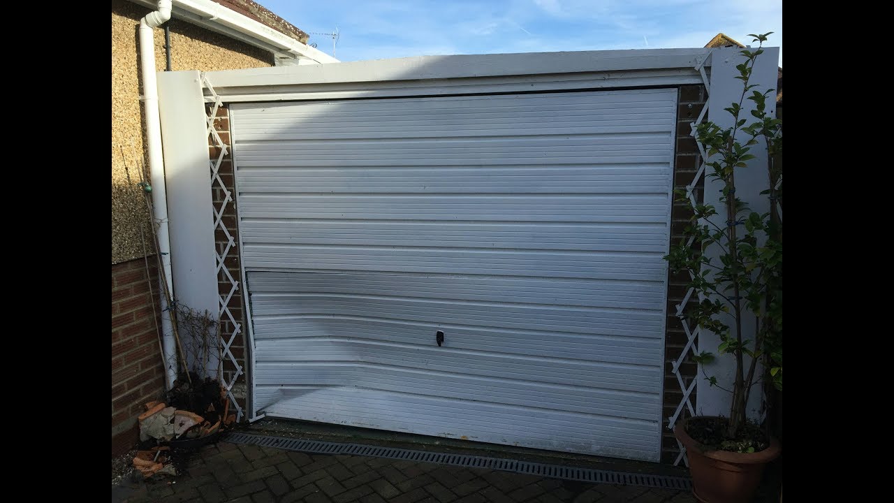 Garage door and front pillar repair following impact. Prefab garage