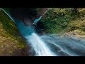 Drone Flies Through Jungle Waterfall