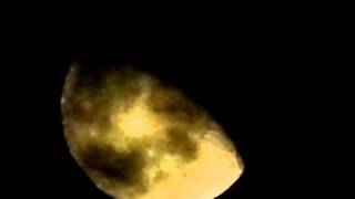 The Moon with clouds drifting past it.