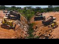 Nice team work filling  land by operator bulldozer spreading stone and many dump truck loading stone