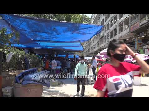 Daily activity around Nehru Place's busy tech market and commercial complex