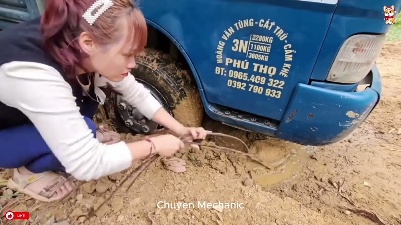 #16 Girl repairs and restores a broken car wheel in the middle of the road.