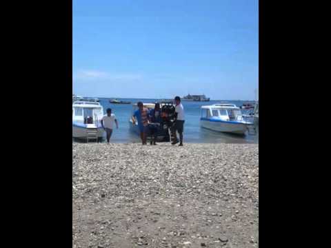 The guys getting my scooter off the boat during our journey off Boracay island
