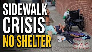 Woman Lays On Portland, Oregon Steets With Clothes Laid Out On the Sidewalk & Wheelchair Next To Her