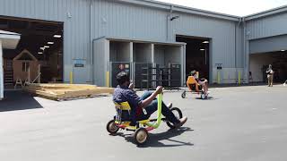 Engineering seniors test drive adult-sized tricycles made in class
