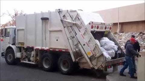 UNM Environmental Services - WHITEGMC Xpeditor Pak-Mor Rear Load Garbage Truck.
