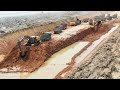 Excavator Digging dirt On Loading Dump Trucks - New Canal Project With Lots of Trucks and Excavators