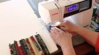 Carol McLeod from Aunties Two shows how to zigzag batting filled strips together.