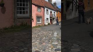 Cairn terrier dog explores Outlander filming locations in Culross, Scotland