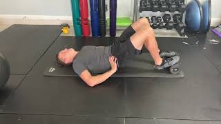 Supine isometric hamstring hold on foam roller