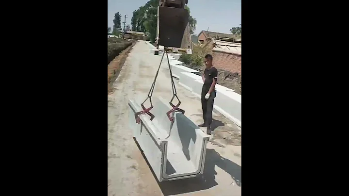 Skilled excavator installing concrete drainage ditch in rural