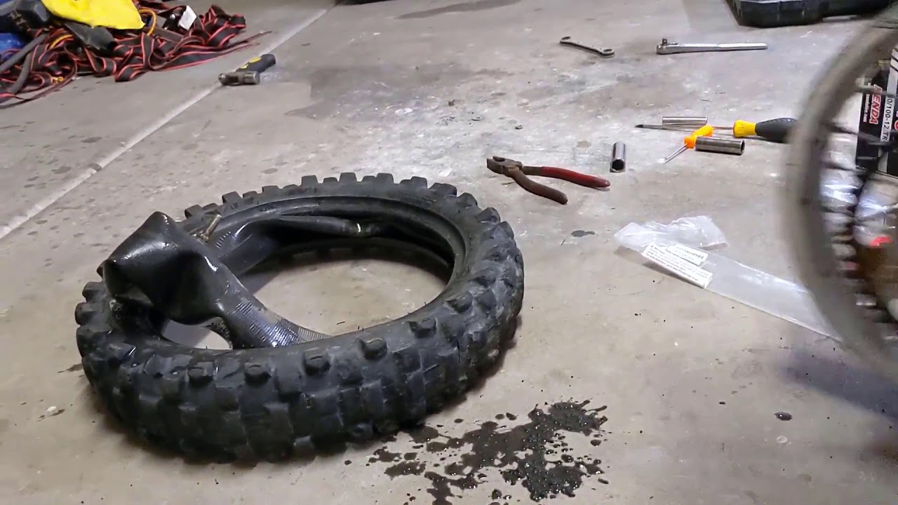 Changing the rear tire on a KX65 - YouTube