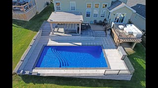 Backyard transformation with Fiberglass Pool, paver patio, and retaining wall