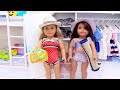 Sister dolls dress with color swimwear to go to the beach for family vacation