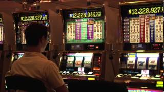 Megabucks Slot Machine in Las Vegas Casino with a Player Pulling Lever Trying for a Winning Jackpot