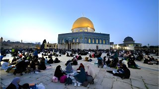 Palestinians break their fast at a mass iftar dinner at the Al Aqsa Mosque