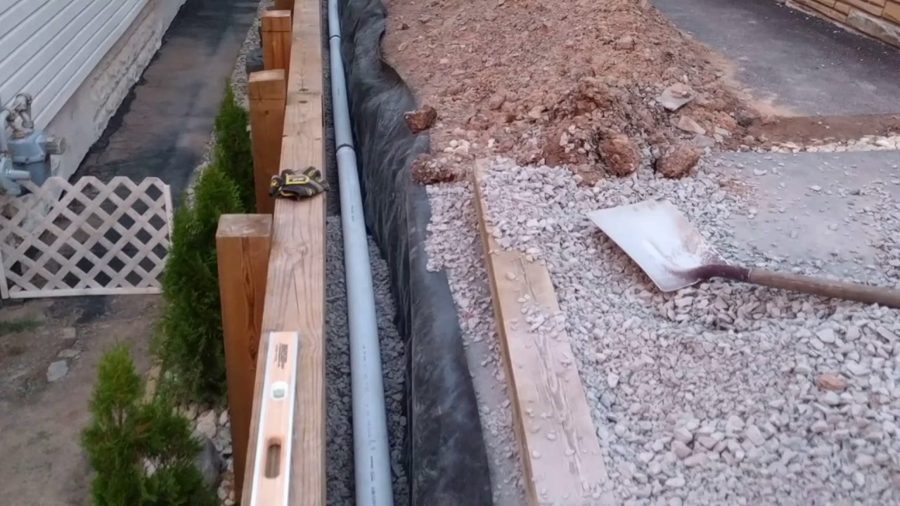 installing drainage for 6x6 retaining wall - YouTube