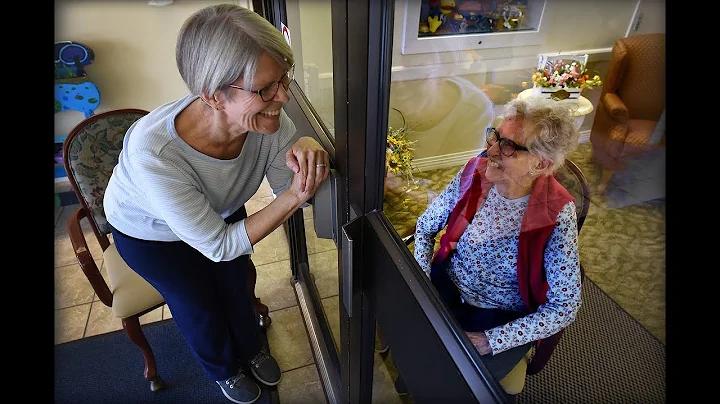 COVID-19 and a glass barrier don't stop conversation between mother and daughter