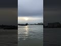 Views down beside River Thames at Greenwich in London looking towards London Bridge on a spring day