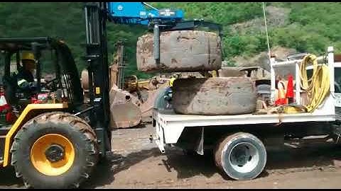 Easy Gripper Tire Handler Equipment on front loader moves OTR tires with ease