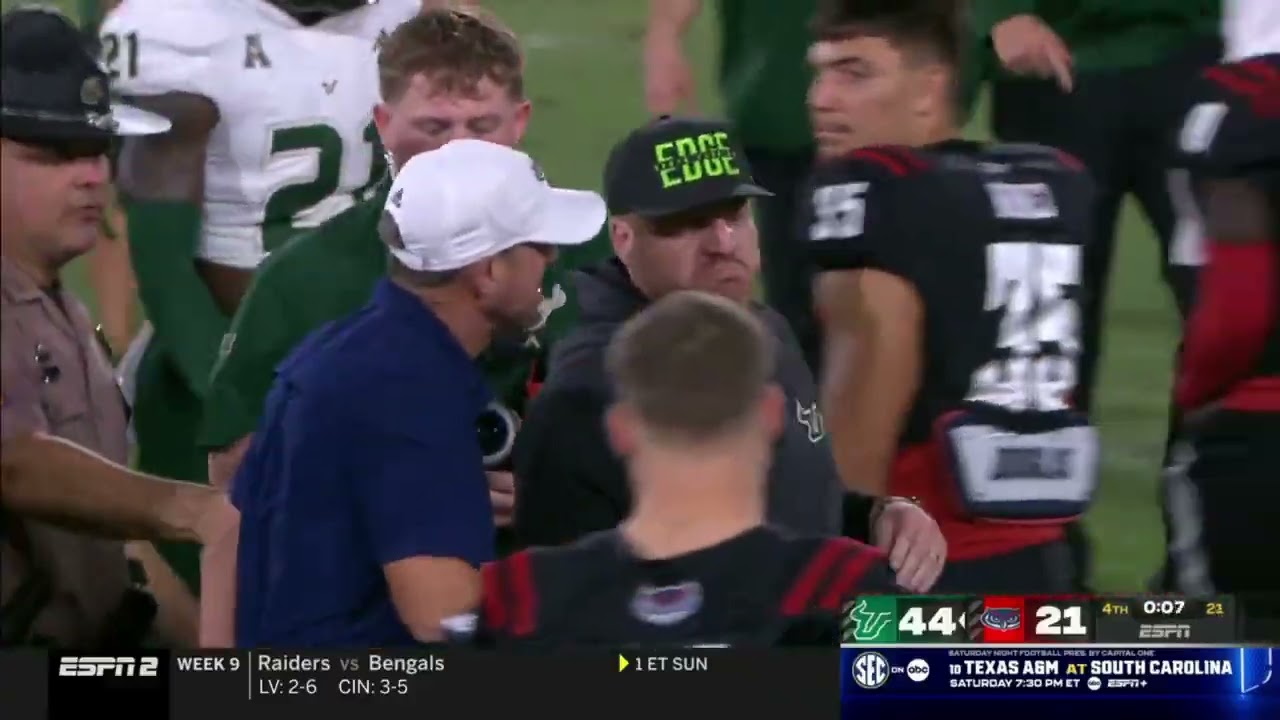 USF coach Alex Golesh brushes off FAU coach Tom Herman's handshake after the Bulls blow out the Owls