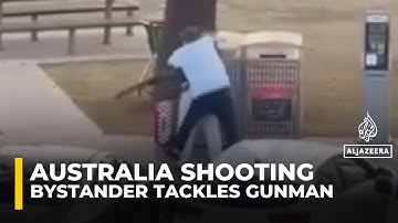 Video shows bystander tackling and disarming one of the shooters at Sydney’s Bondi Beach