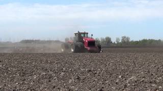 Versatile 550 Tractor pulling a 60 foot wide field cultivator near Kensett Iowa