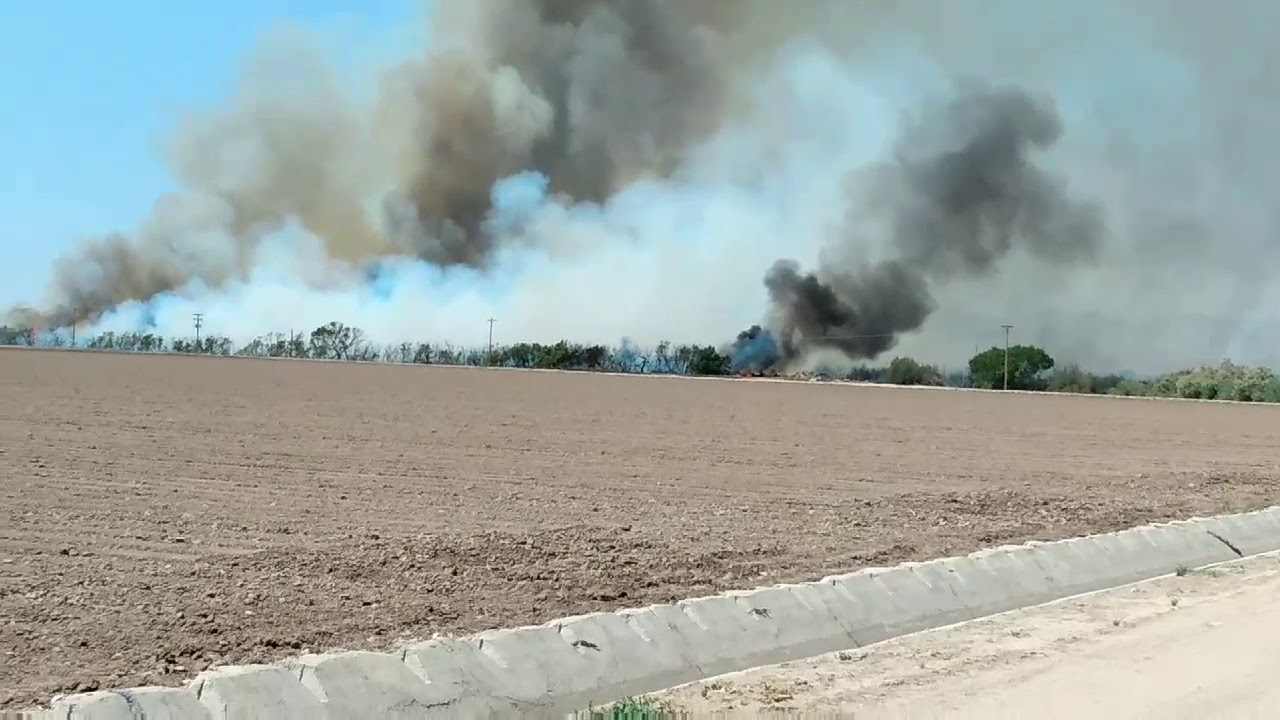 Fire in Thatcher Az. The brush by the river is burning out of control