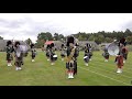 Huntly Pipe Band march on to start their displays during 2021 Grampian Highland Games in Scotland