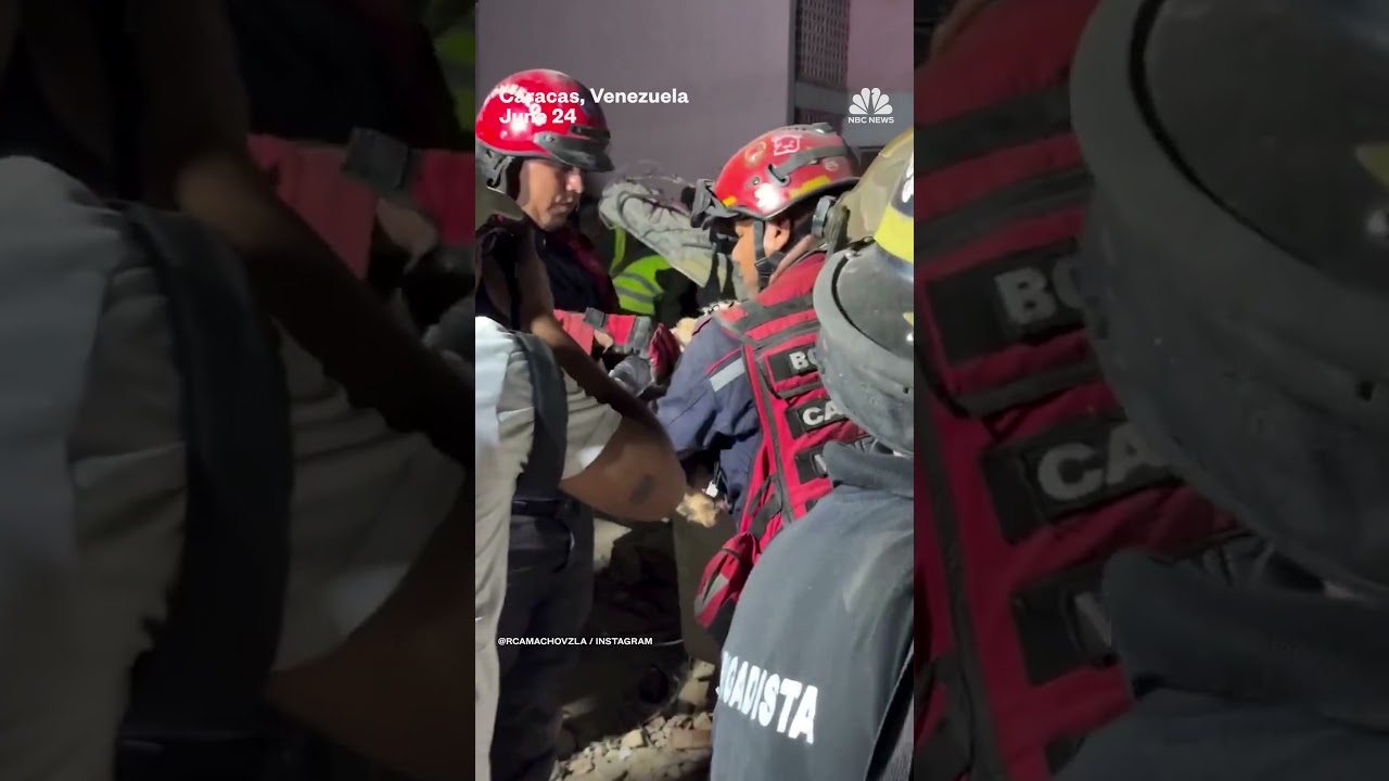 Firefighters give water to rescued dog in Caracas