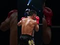 Middleweight Muay Thai bout under dramatic overhead lighting  Fighters exchanging slicing elbows in