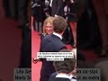 Léa Seydoux sneakily leans on co-star Niels Schneider to squeeze out an extra hug at Cannes exit
