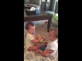 Funny twin baby girls fighting over soothers.