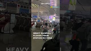 Torrential downpour floods South China train station