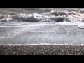 Waves on a pebble beach. Free HD stock footage.