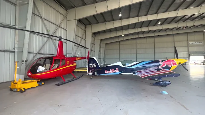 Red Bull Extra 300 Plane and Robinson 44 Helicopter In Hangar